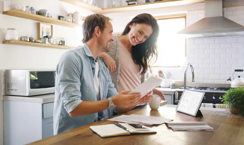 Couple, happy and tablet with documents at house for financial planning, bank balance and debt payment. Man, woman and paperwork for budget savings, property